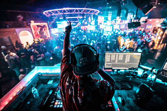 A DJ shouting to the crowd at a bar